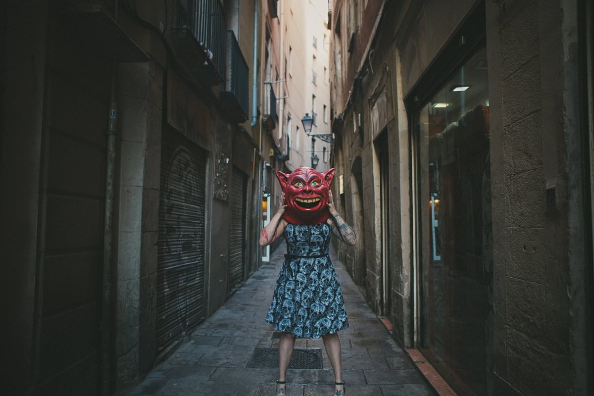 Portrait of woman standing in Barcelona Gothic Quarter street wearing mask photography